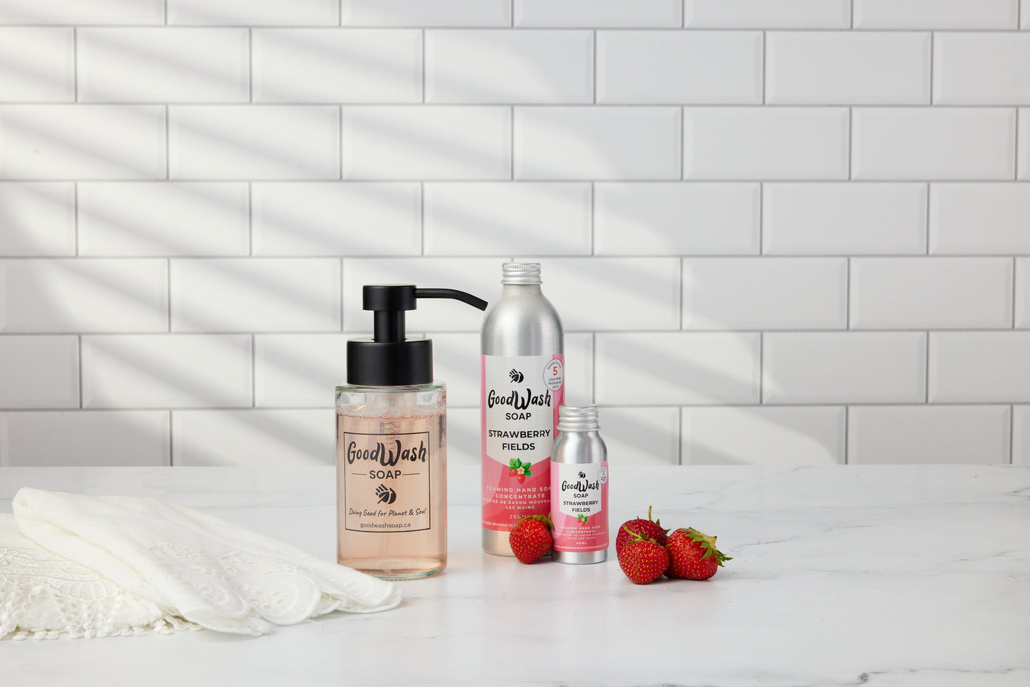 Goodwash Strawberry Fields foaming hand soap refill concentrate and Dispenser bottle on a white bathroom countertop