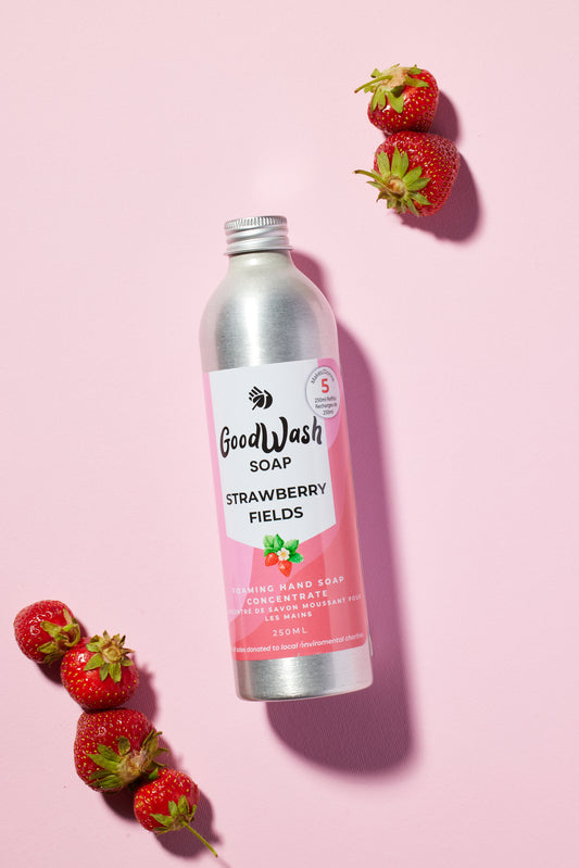 Strawberry Fields foaming hand soap refill concentrate 250ml bottle on a pink background with strawberries